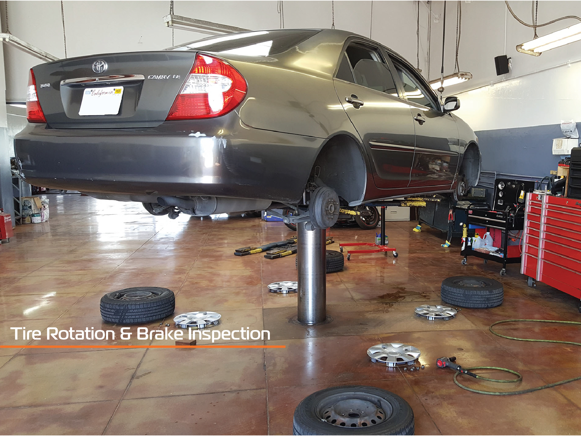 A tire rotation and brake inspection on a Grey Toyota Camry